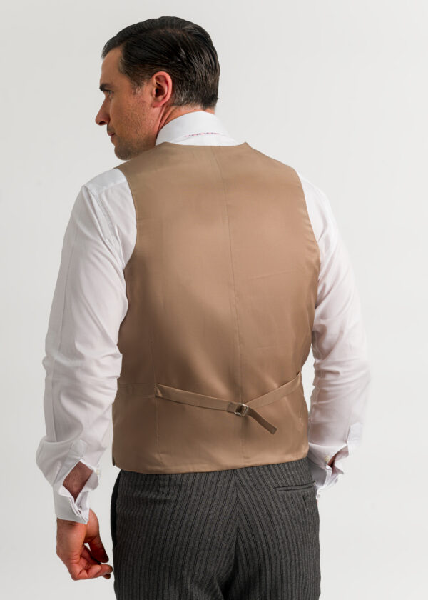 The back of a traditional men's formal waistcoat in tan.