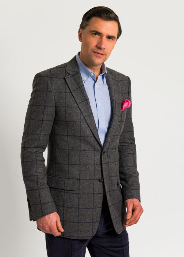 A contemporary take on a tweed jacket, grey with a stunning blue woven as an overcheck.