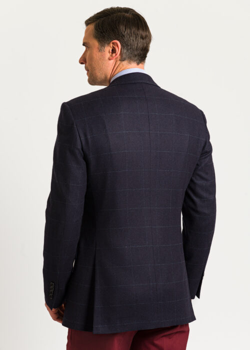 Back of a men's navy tweed jacket in a modern tailored fit.