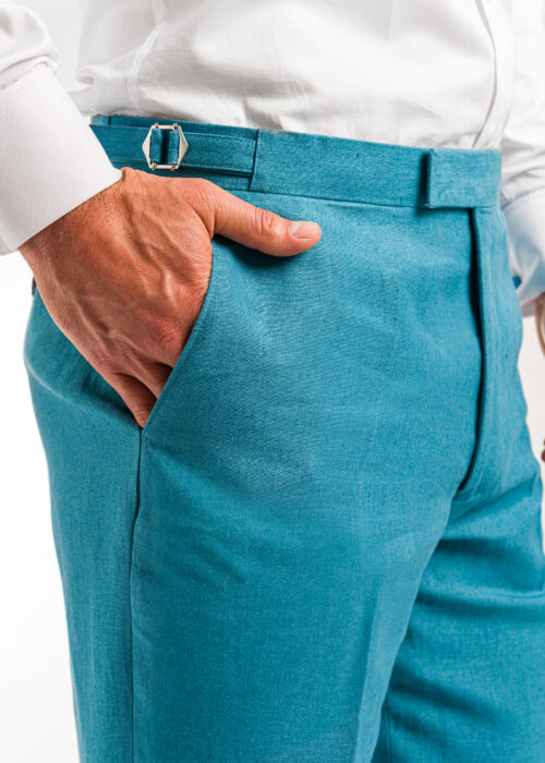 The pocket detail of men's smart teal linen trousers.