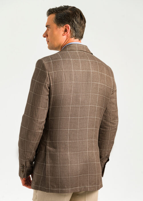 The back of a men's windowpane checked tan linen blazer.