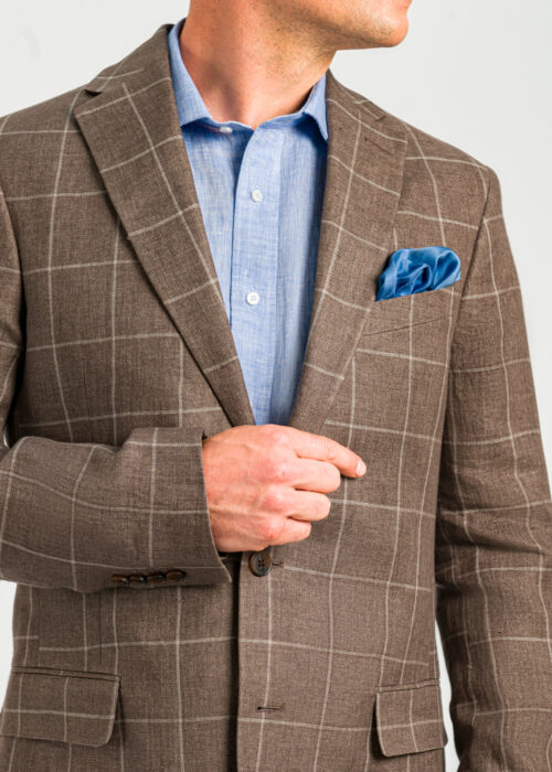 Checked linen jacket styled with blue shirt and silk pocket square.