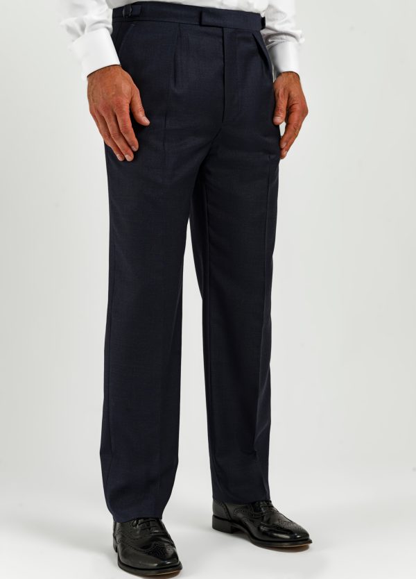 The pleated front of a pair of blue microcheck suit trousers from Roderick Charles London.