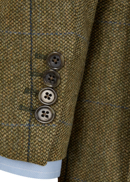 Detail shot of the four button sham-hole cuff of a green and blue windowpane jacket