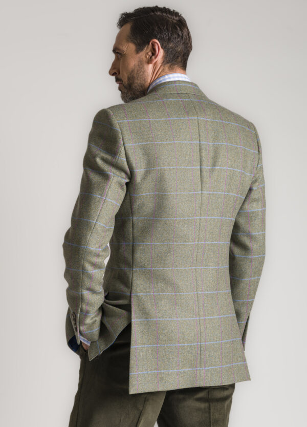 The back of a Roderick Charles tweed jacket, showing the bright sky and pink windowpane check