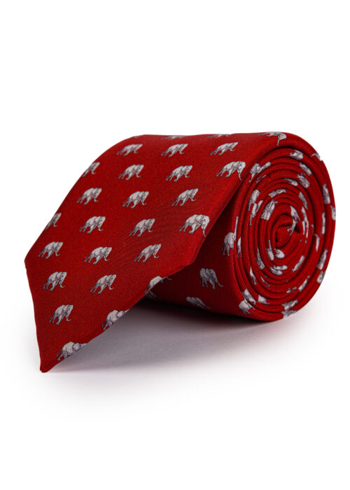 A rolled up Roderick Charles red silk tie with elephants