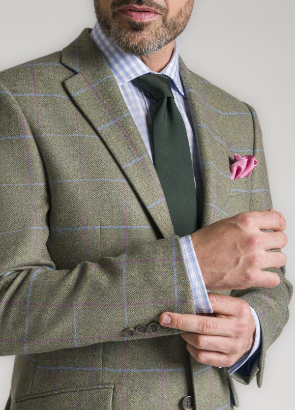 A Roderick Charles tweed jacket, featuring a sky and pink windowpane check on a herringbone weave, paired with a bright pink silk pocket square